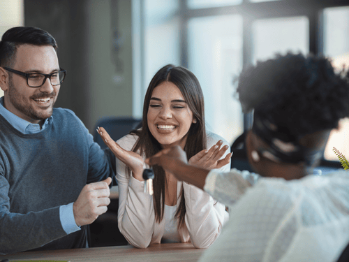 Young couple learning about 1% down conventional first time home-buyer loan program.